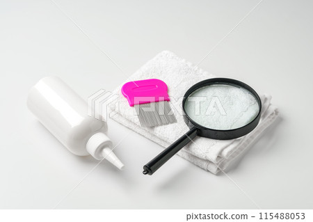 Cosmetic products, lice comb and magnifying glass isolated on white Cosmetic products, lice comb and magnifying glass isolated on white 115488053