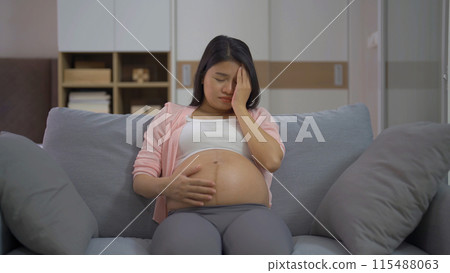 Depressed lonely Asian pregnant divorce woman in bedroom at home. Having a baby. Family people lifestyle. Mom. Depressed lonely Asian pregnant divorce woman in bedroom at home. Having a baby. Family people lifestyle. Mom. 115488063