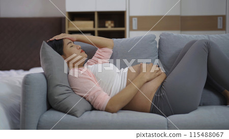 Depressed lonely Asian pregnant divorce woman in bedroom at home. Having a baby. Family people lifestyle. Mom. Depressed lonely Asian pregnant divorce woman in bedroom at home. Having a baby. Family people lifestyle. Mom. 115488067