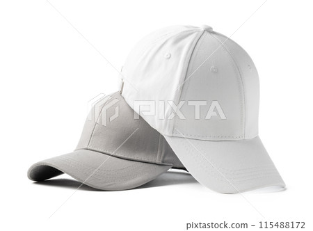 Two Basic Baseball Caps Positioned Side by Side on a White Background Two Basic Baseball Caps Positioned Side by Side on a White Background 115488172