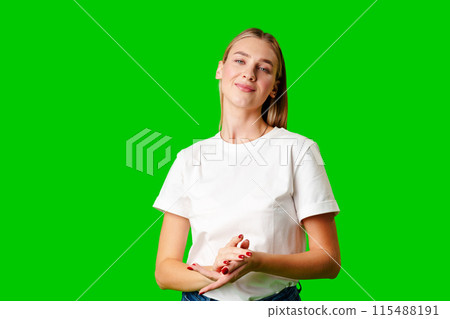 Young Woman in White Shirt Posing for Picture against green background Young Woman in White Shirt Posing for Picture against green background 115488191