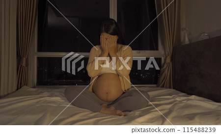 Depressed lonely Asian pregnant divorce woman in bedroom at home. Having a baby. Family people lifestyle. Mom. Depressed lonely Asian pregnant divorce woman in bedroom at home. Having a baby. Family people lifestyle. Mom. 115488239