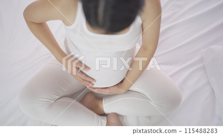 A Portrait of happy Asian pregnant woman in bedroom at home. Having a baby. Family people lifestyle. Love. 115488283