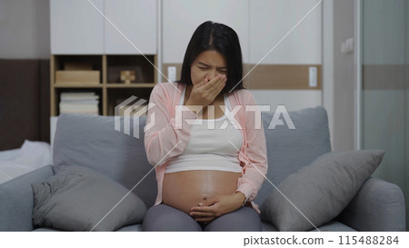 Depressed lonely Asian pregnant divorce woman in bedroom at home. Having a baby. Family people lifestyle. Mom. Depressed lonely Asian pregnant divorce woman in bedroom at home. Having a baby. Family people lifestyle. Mom. 115488284