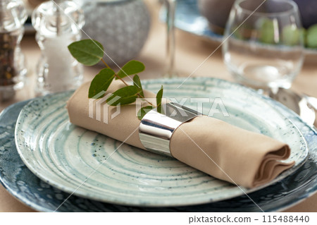 Stylish serving on a green ceramic plate with cotton napkin Stylish serving on a green ceramic plate with cotton napkin 115488440