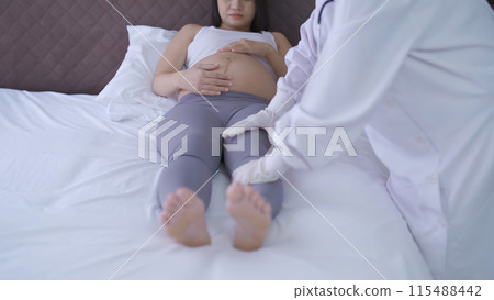 A portrait of happy Asian pregnant woman checkup with a doctor in bedroom at home. Having a baby. Family people lifestyle. Mom love. 115488442