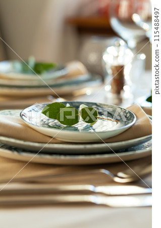 Elegant dinner table served for banquet event 115488497