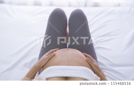 A Portrait of happy Asian pregnant woman in bedroom at home. Having a baby. Family people lifestyle. Love. 115488516