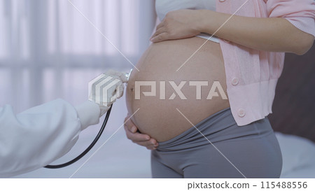 A portrait of happy Asian pregnant woman checkup with a doctor in bedroom at home. Having a baby. Family people lifestyle. Mom love. A portrait of happy Asian pregnant woman checkup with a doctor in bedroom at home. Having a baby. Family people lifestyle. Mom love. 115488556