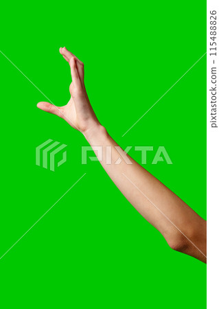 A womans hand extends upward into the air, fingers outstretched, reaching upward towards an unseen destination. A womans hand extends upward into the air, fingers outstretched, reaching upward towards an unseen destination. 115488826