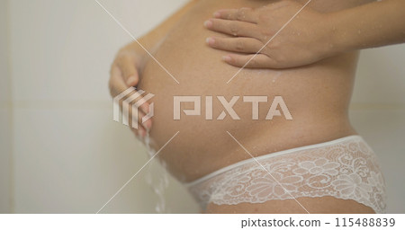 A portrait of happy Asian pregnant woman taking a shower. Having a baby. Family people lifestyle. Mom love. 115488839
