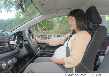 A Portrait of happy Asian pregnant woman driving a car vehicle. Having a baby. Family people lifestyle. Mom love. Journey. 115489192
