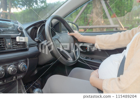 A Portrait of happy Asian pregnant woman driving a car vehicle. Having a baby. Family people lifestyle. Mom love. Journey. 115489204