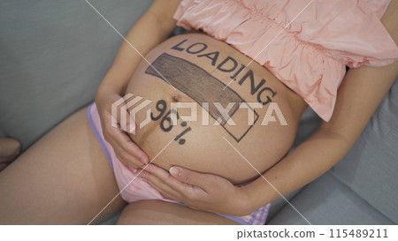 A portrait of happy Asian pregnant woman loading, counting down for baby in bedroom at home. Having a baby. Family people lifestyle. Mom love. A portrait of happy Asian pregnant woman loading, counting down for baby in bedroom at home. Having a baby. Family people lifestyle. Mom love. 115489211