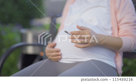 A Portrait of Asian pregnant woman smoking cigarette. Having a baby. Family people lifestyle. Mom love. 115489216