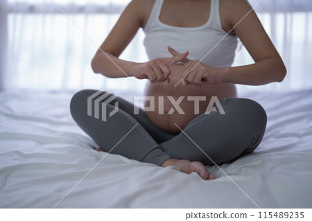 A Portrait of Asian pregnant woman smoking cigarette. Having a baby. Family people lifestyle. Mom love. 115489235