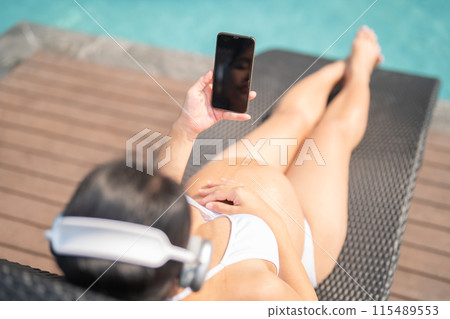 A portrait of happy Asian pregnant woman by the swimming pool. People lifestyle in travel holiday vacation concept. Relaxation. Having a baby. Family people lifestyle. Mom love. 115489553