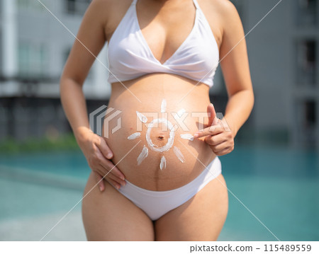 A portrait of happy Asian pregnant woman by the swimming pool. People lifestyle in travel holiday vacation concept. Relaxation. Having a baby. Family people lifestyle. Mom love. A portrait of happy Asian pregnant woman by the swimming pool. People lifestyle in travel holiday vacation concept. Relaxation. Having a baby. Family people lifestyle. Mom love. 115489559