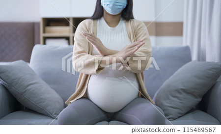Depressed lonely Asian pregnant divorce woman with a mask for protecting covid-19 in bedroom at home. Having a baby. Family people lifestyle. Mom. quarantine 115489567