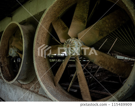looking inside the livestock house through the space of the exhaust fan blade 115489909