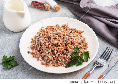 Boiled buckwheat on a plate. Healthy porridge enriched with vitamins. copy space, 115490581