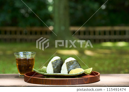 Eating onigiri outdoors Eating onigiri outdoors 115491474