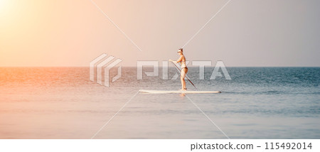 Sea woman sup. Silhouette of happy middle aged tanned woman in rainbow bikini, surfing on SUP board, confident paddling through water surface. Idyllic sunset. Active lifestyle at sea or river. Sea woman sup. Silhouette of happy middle aged tanned woman in rainbow bikini, surfing on SUP board, confident paddling through water surface. Idyllic sunset. Active lifestyle at sea or river. 115492014