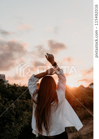 Woman summer travel sea. Happy tourist enjoy taking selfie photo outdoors for memories. Woman traveler posing on the beach at sea surrounded by volcanic mountains, sharing travel adventure journey 115492016