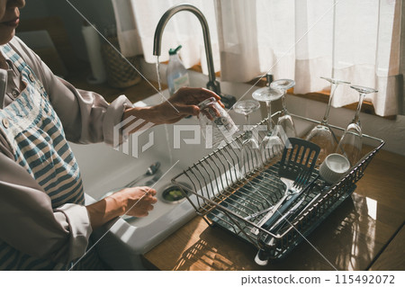 Place washed glasses in a drainer 115492072