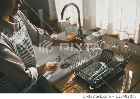 Place washed glasses in a drainer 115492073