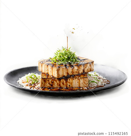 Marinated tofu steaks juicy and flavorful sizzling and flipping with a misty spray of teriyaki 115492165