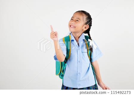 Portrait smiling Asian little girl kindergarten with schoolbag pointing finger at copy space studio shot isolated white background, happy woman kid in pigtails wearing school uniform, back to school Portrait smiling Asian little girl kindergarten with schoolbag pointing finger at copy space studio shot isolated white background, happy woman kid in pigtails wearing school uniform, back to school 115492273