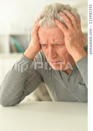 close-up portrait of a senior man thinking about something close-up portrait of a senior man thinking about something 115492355
