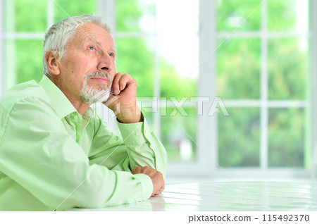 close-up portrait of a senior man thinking about something close-up portrait of a senior man thinking about something 115492370