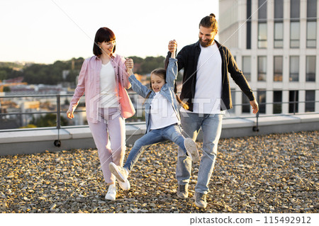 Happy family enjoying time together on urban rooftop Happy family enjoying time together on urban rooftop 115492912