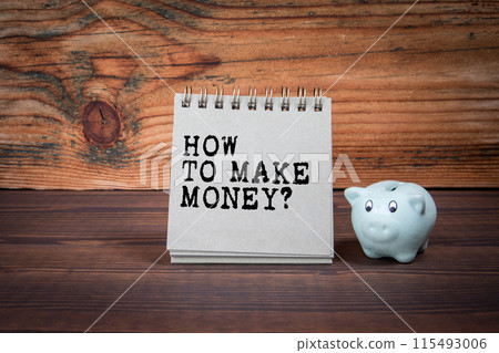 How To Make Money. Cardboard notepad on wooden texture table 115493006