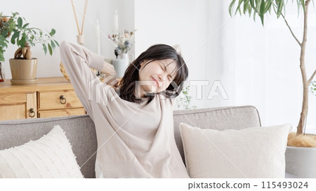 A woman stretching to wake up A woman stretching to wake up 115493024