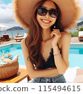 Young woman wearing sunglasses and straw hat at the pool 115494615