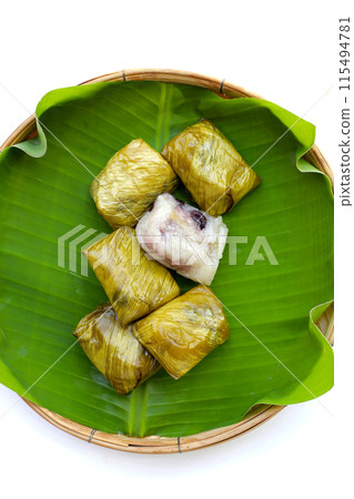 Bundled boiled sticky rice with banana and black beans wrapped in banana leaves Bundled boiled sticky rice with banana and black beans wrapped in banana leaves 115494781