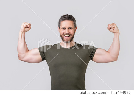 photo of shouting strong muscular man with stubble. strong muscular man wear tshirt. photo of shouting strong muscular man with stubble. strong muscular man wear tshirt. 115494932