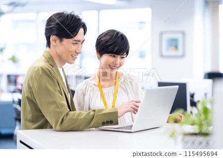 Young male and female engineers having a meeting in the office Young male and female engineers having a meeting in the office 115495694