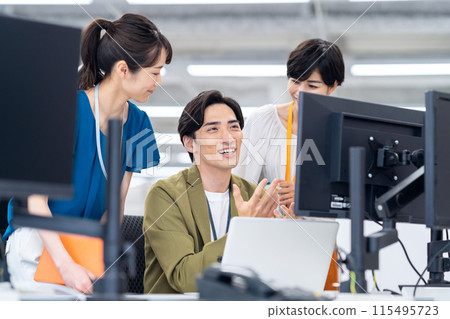 Young male and female engineers having a meeting in the office Young male and female engineers having a meeting in the office 115495723