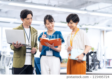 Young male and female engineers having a meeting in the office 115495724