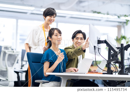 Young male and female engineers having a meeting in the office 115495734