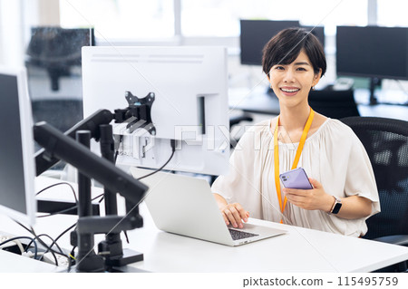 Young female engineer working in an office 115495759