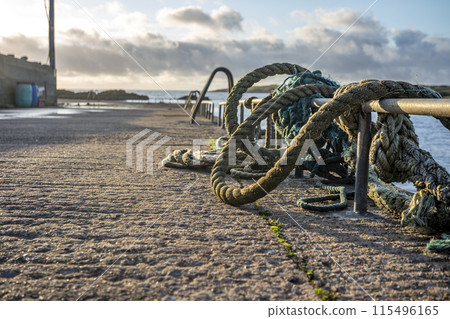 Ropes and ladder into the sea at coastal harbour 115496165