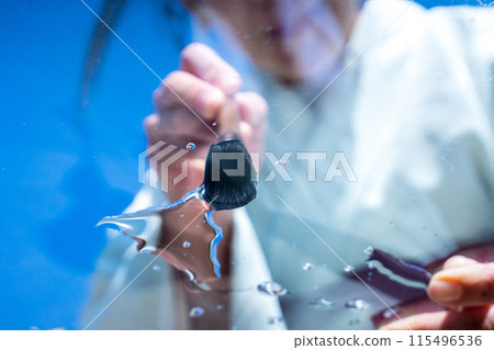 A woman in a kimono and a brush painting summer water A woman in a kimono and a brush painting summer water 115496536