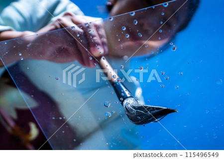 A woman in a kimono and a brush painting summer water 115496549