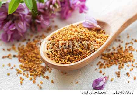 Healthy bee pollen grains. Bee pollen on a wooden spoon Healthy bee pollen grains. Bee pollen on a wooden spoon 115497353