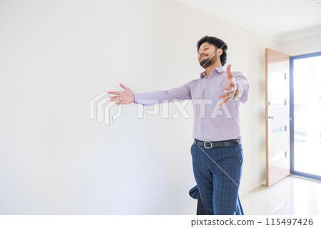 A man returning home and spreading his hands 115497426